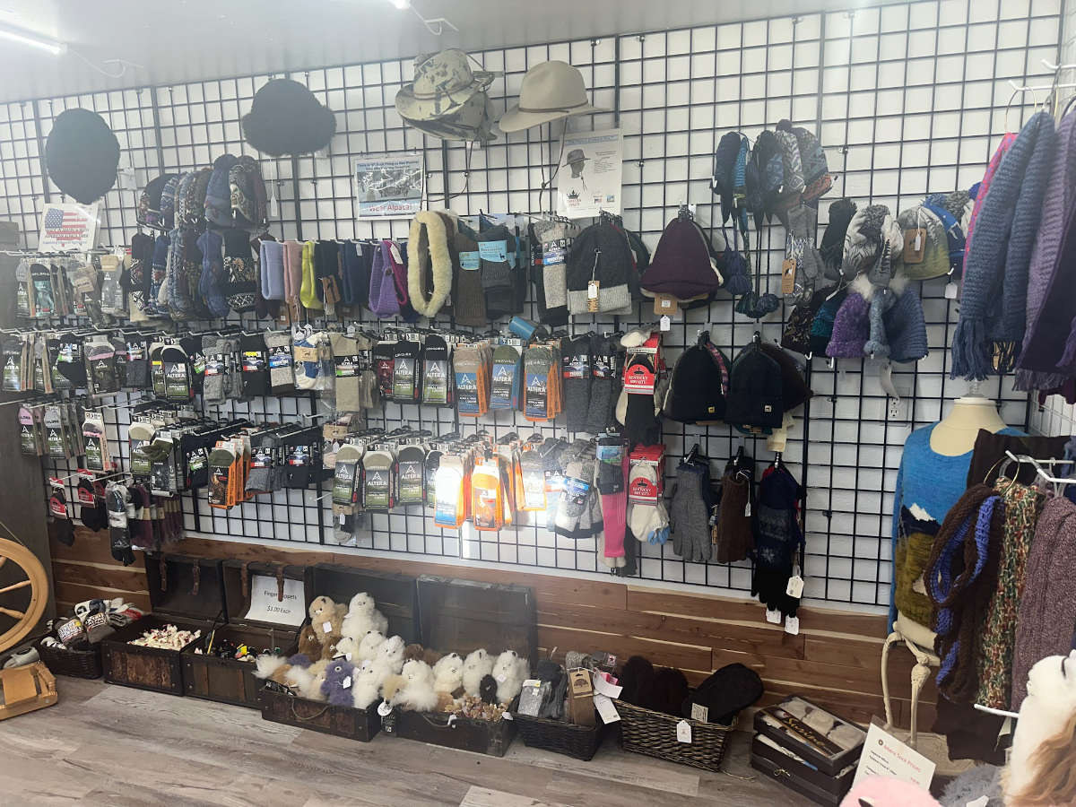 Display of socks, alpaca winter hats, scarves, gloves, and neck warmers to gift to others or protect you from the winter elements