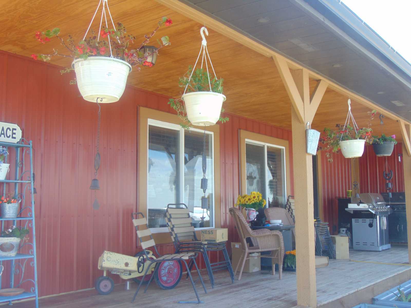 east facing porch with flower baskets and plenty of chairs to sit in